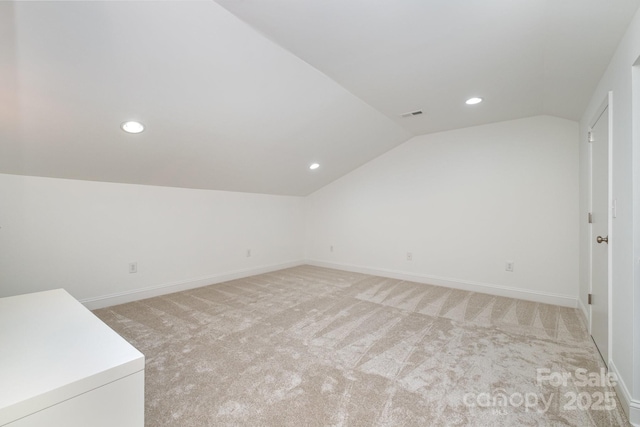 bonus room featuring lofted ceiling and light carpet