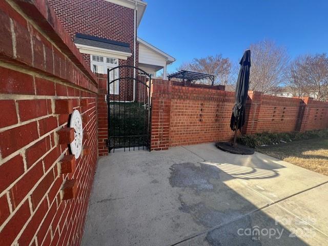 view of gate with a patio area