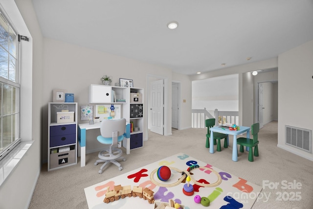 game room featuring light colored carpet