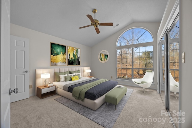 bedroom with ceiling fan, light colored carpet, and vaulted ceiling