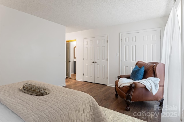 bedroom with hardwood / wood-style floors and a textured ceiling