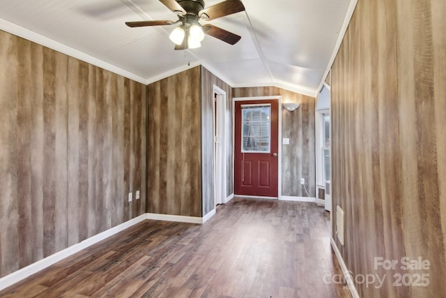 foyer entrance featuring ceiling fan, vaulted ceiling, crown molding, and dark hardwood / wood-style floors