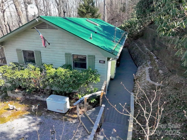 view of side of home with metal roof