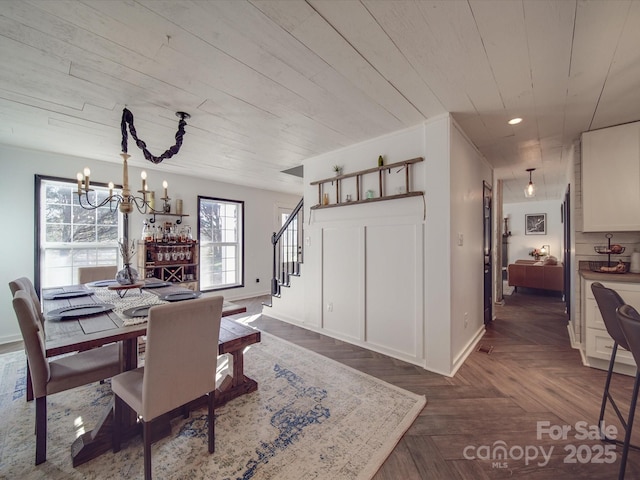 dining space with baseboards, stairway, a notable chandelier, and recessed lighting