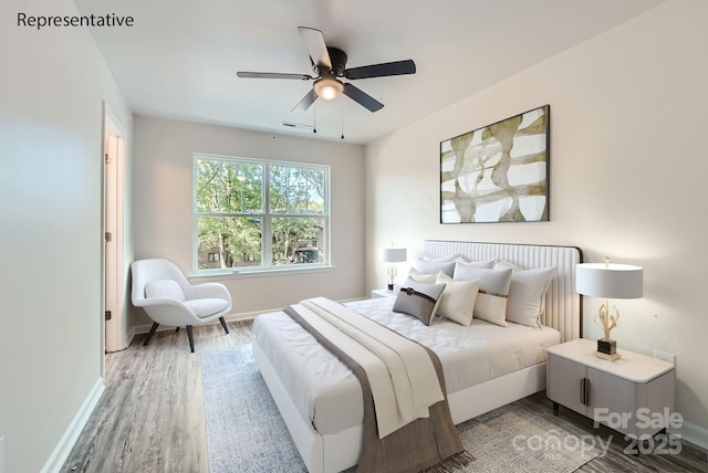 bedroom with ceiling fan and light hardwood / wood-style floors