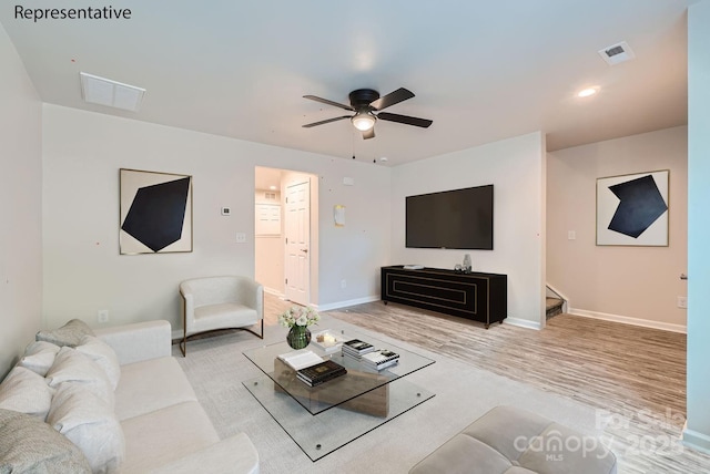 living room featuring ceiling fan and light hardwood / wood-style flooring