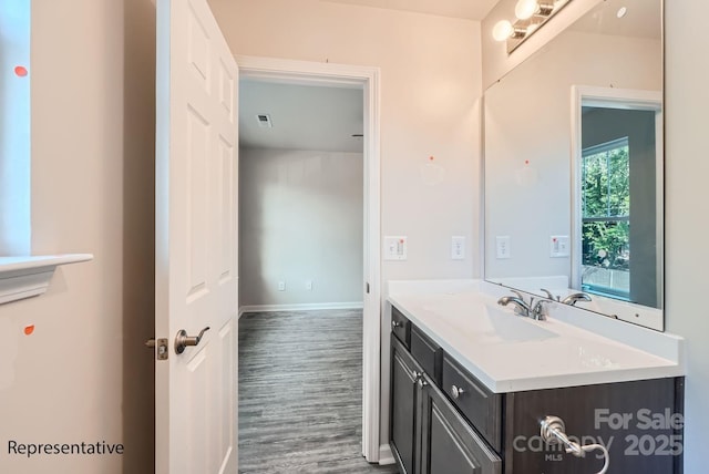 bathroom with vanity and hardwood / wood-style flooring