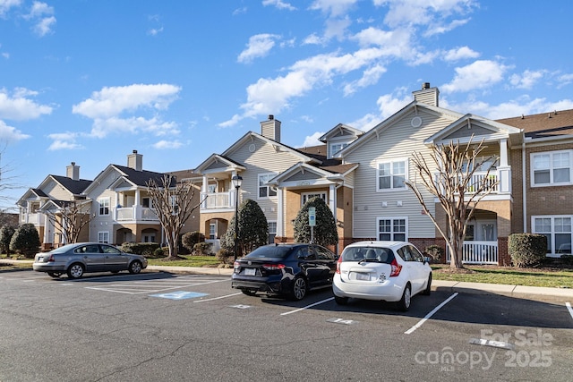 view of property featuring a residential view and uncovered parking