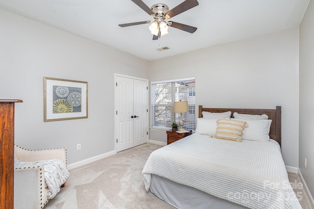 carpeted bedroom with ceiling fan, a closet, visible vents, and baseboards