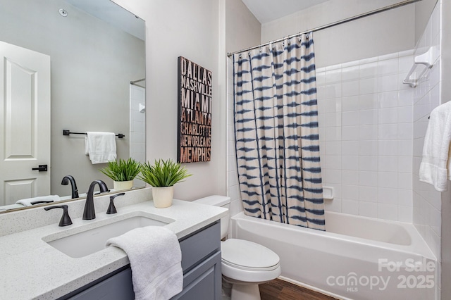 full bath featuring wood finished floors, shower / bath combo, vanity, and toilet