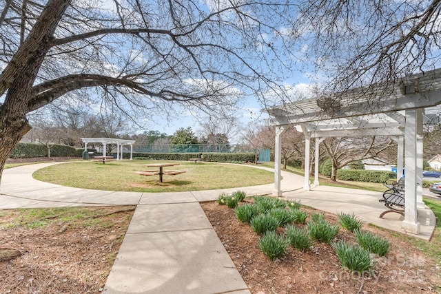 view of community with a lawn and a pergola