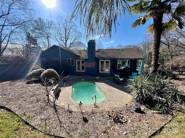 view of pool with a patio and french doors