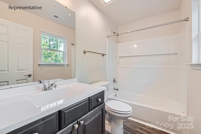 full bathroom featuring wood-type flooring, shower / tub combination, vanity, and toilet