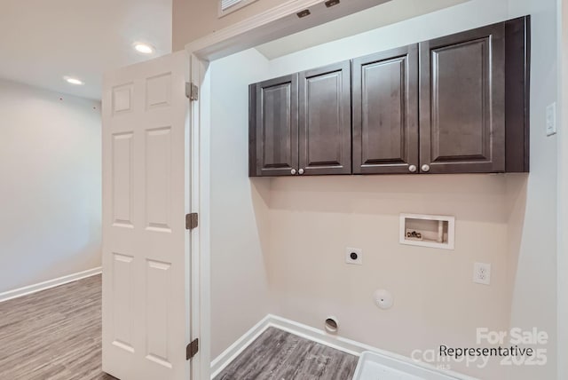 laundry area featuring light hardwood / wood-style floors, electric dryer hookup, washer hookup, cabinets, and gas dryer hookup