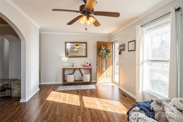 entryway featuring ceiling fan, crown molding, and dark hardwood / wood-style floors