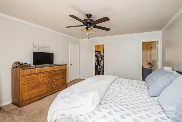 carpeted bedroom with ceiling fan, ensuite bathroom, crown molding, a spacious closet, and a closet