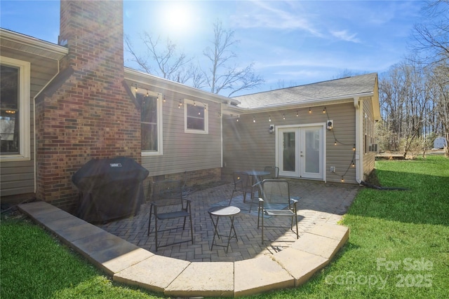 back of house with a lawn, french doors, and a patio