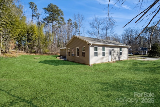 view of side of property with a lawn