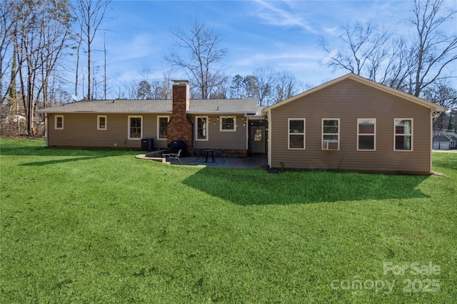 rear view of property with a lawn, central AC unit, and a patio area