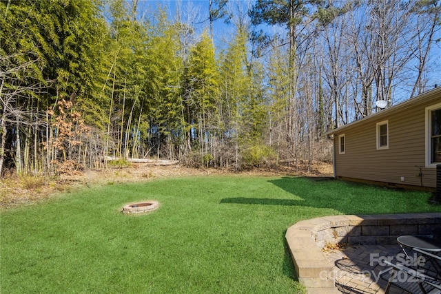 view of yard with a fire pit