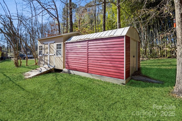 view of outbuilding with a yard