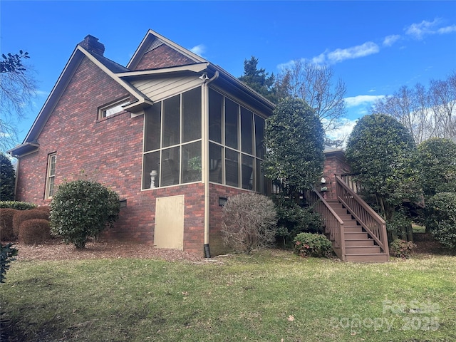 view of property exterior featuring a yard and a sunroom