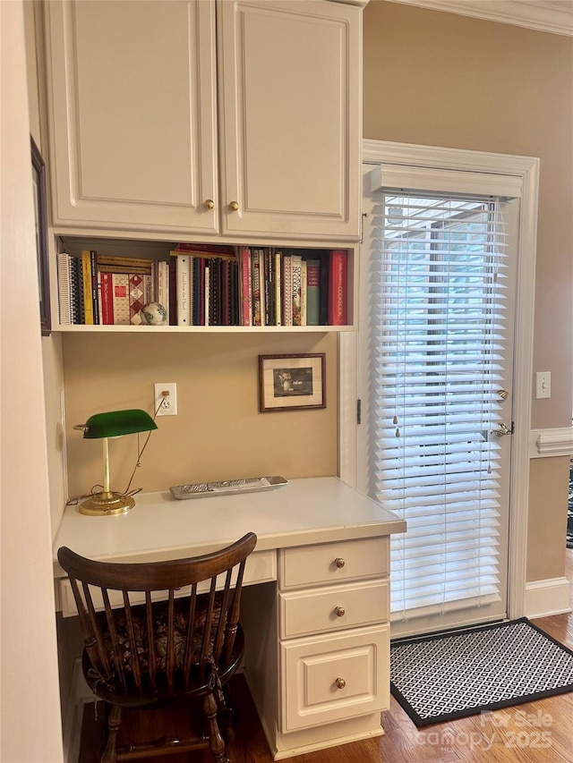 office space with hardwood / wood-style flooring and built in desk