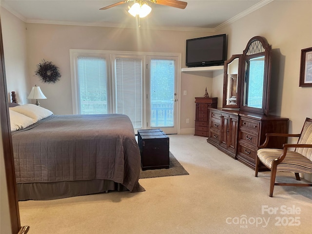 carpeted bedroom with ceiling fan, access to exterior, and ornamental molding