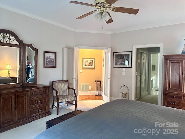 bedroom with ensuite bath, light colored carpet, ceiling fan, and ornamental molding