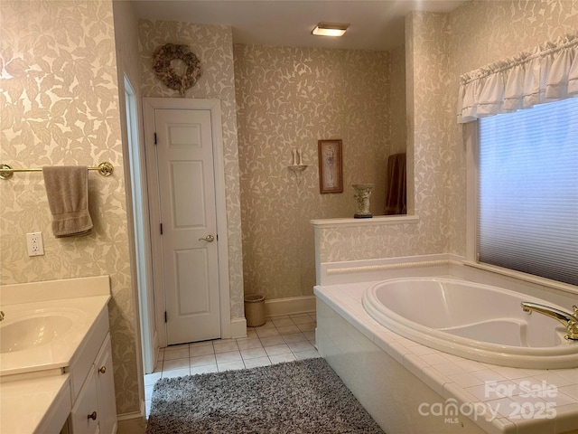 bathroom featuring tiled bath, tile patterned floors, and vanity