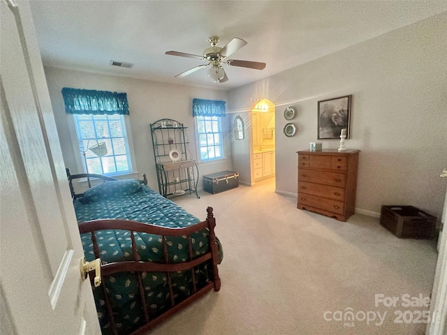 carpeted bedroom with ceiling fan and connected bathroom