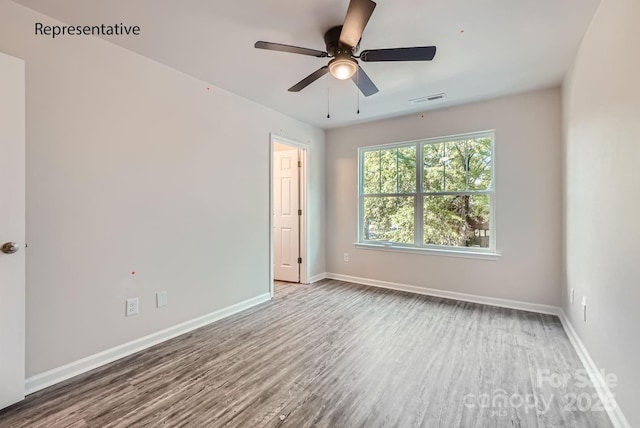 unfurnished room with ceiling fan and hardwood / wood-style floors