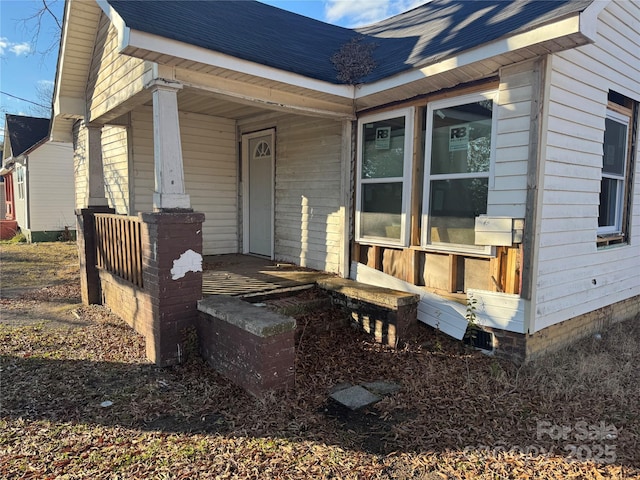 view of exterior entry with covered porch