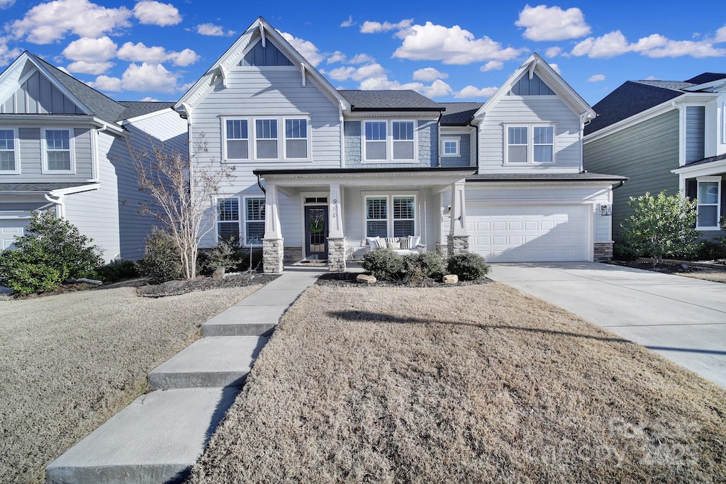 multi unit property featuring a porch and a garage