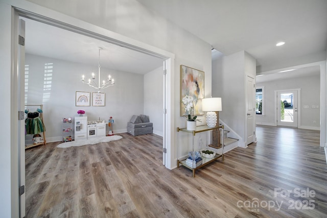 interior space featuring an inviting chandelier and wood-type flooring