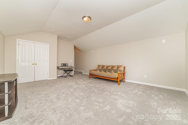 sitting room with carpet flooring and lofted ceiling