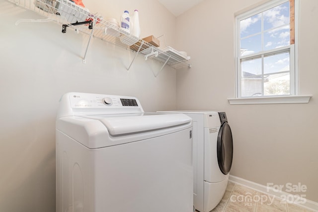 clothes washing area with light tile patterned floors and independent washer and dryer