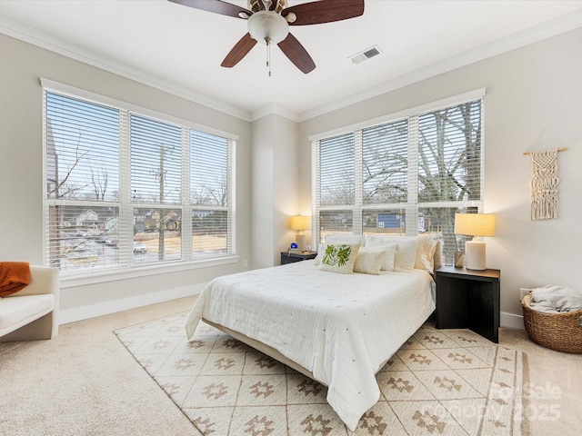 carpeted bedroom featuring ornamental molding and ceiling fan