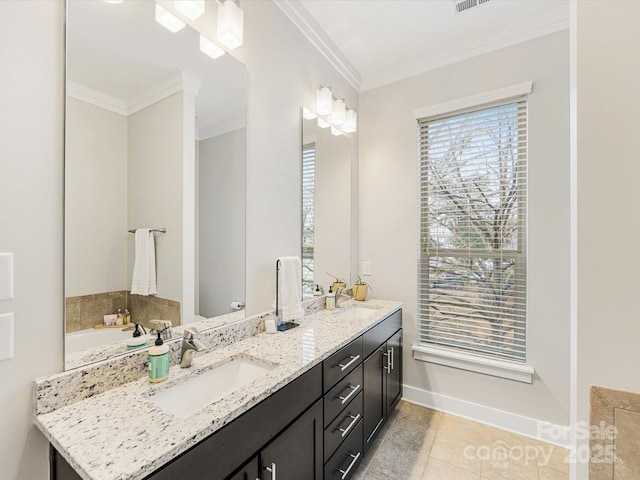 bathroom featuring crown molding, tile patterned floors, vanity, and a bathing tub