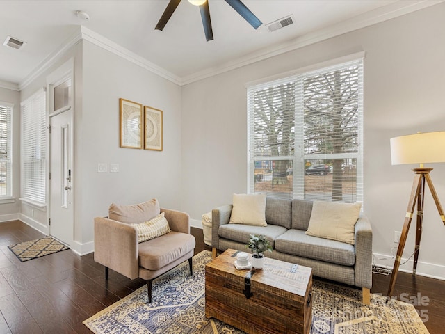 living room with crown molding, dark wood-type flooring, and ceiling fan