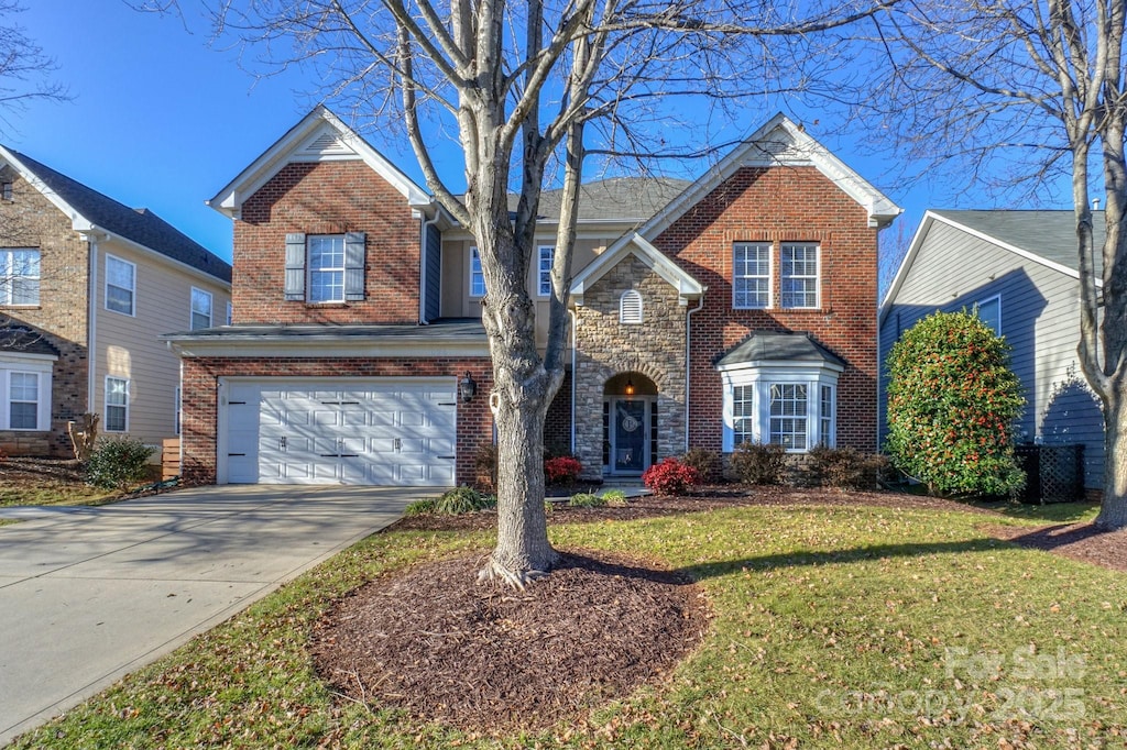 view of front property featuring a front lawn and a garage