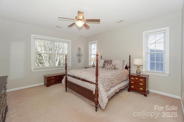 carpeted bedroom featuring multiple windows and ceiling fan