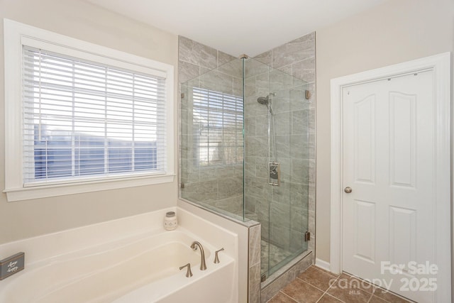 bathroom with independent shower and bath and tile patterned floors