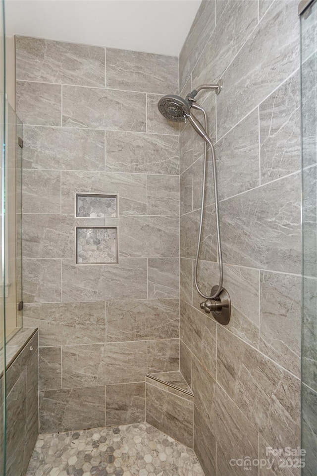 bathroom with a tile shower