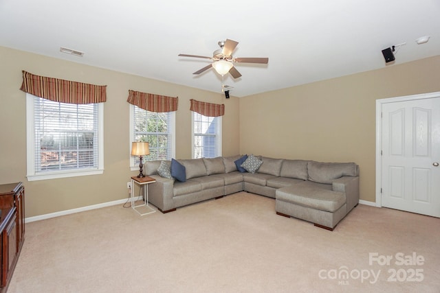 carpeted living room featuring ceiling fan