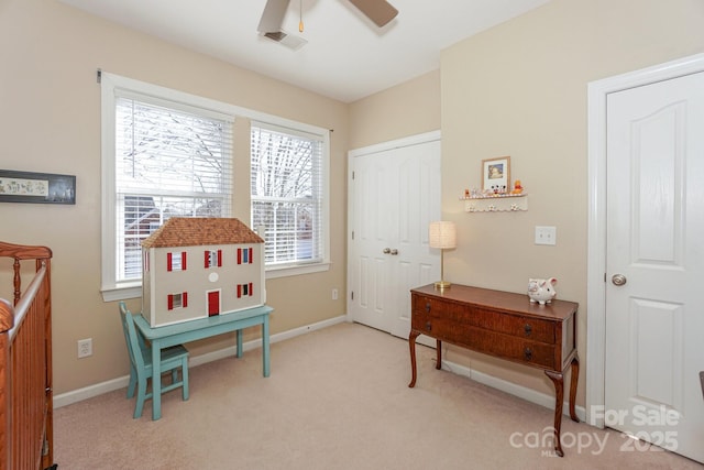 recreation room with light carpet and ceiling fan