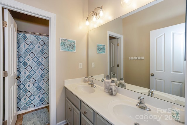 bathroom featuring tile patterned flooring, a shower with shower curtain, and vanity