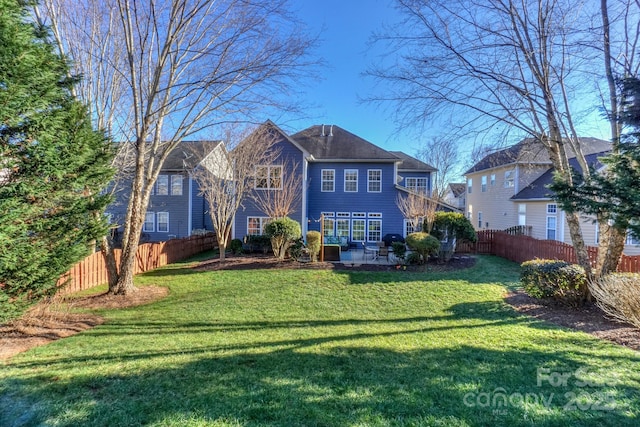 view of front of home featuring a front yard and a patio