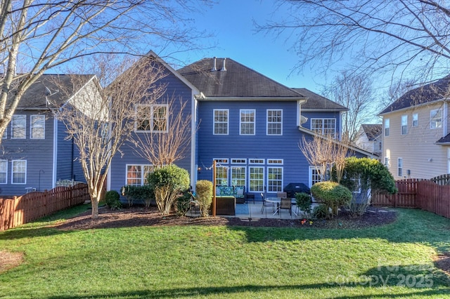 rear view of property with a yard and a patio area