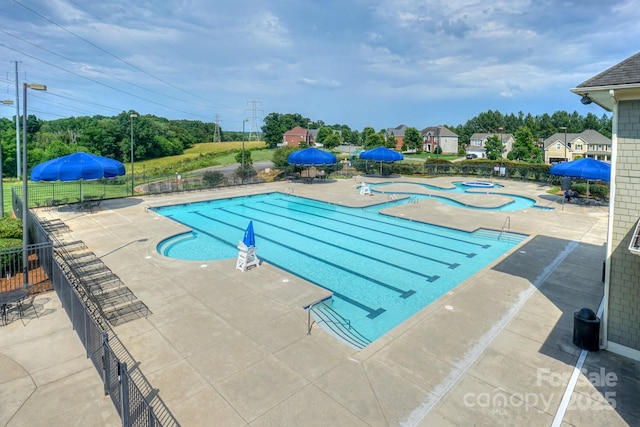 view of pool with a jacuzzi and a patio